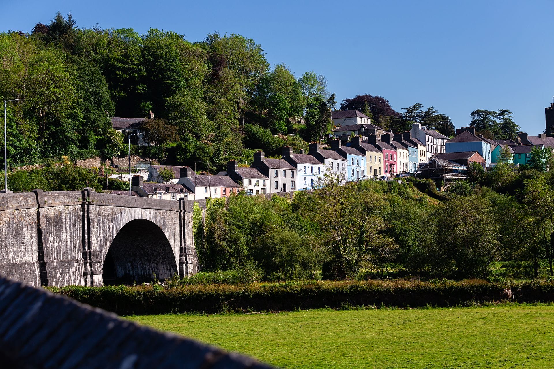 Colourful pastel-painted Georgian houses lining a quiet residential street in Llandeilo, Carmarthenshire, west Wales.