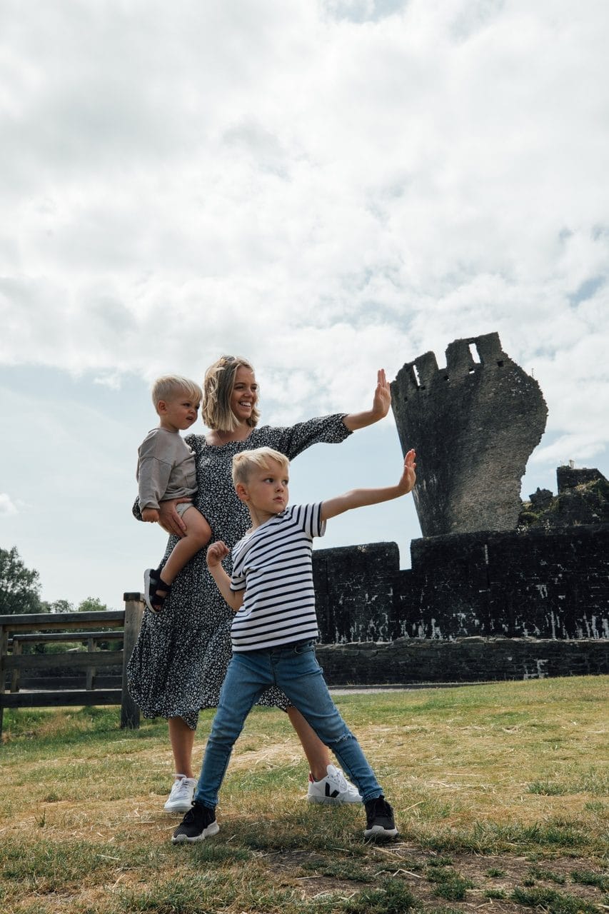Leaning tower of Caerphilly with a family looking like they are pushing it