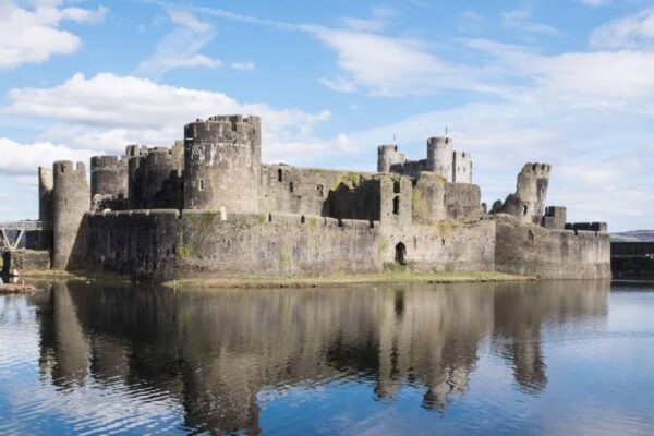 Caerphilly Castle and moat reflecting the towers in South Wales