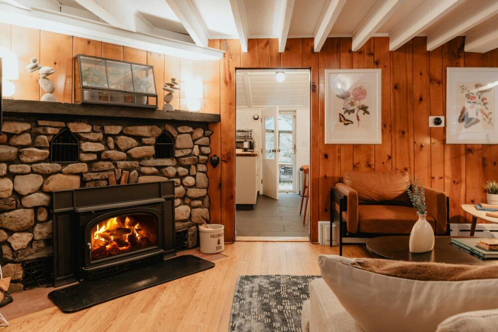 Cosy Cottage in Wales with wooden flooring and a lit fire