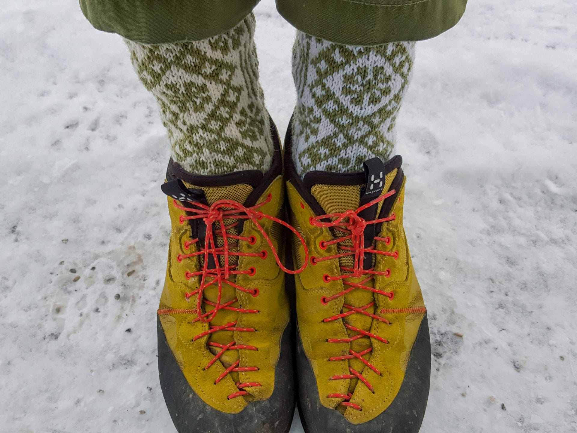 Bright yellow hiking with  patterned socks showing 