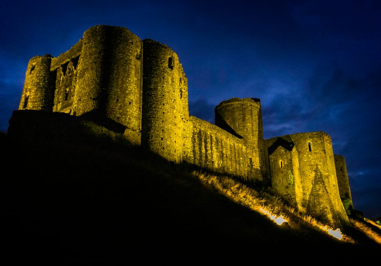 Kidwelly Castle at night lit up by lights -one of the nicest castles in Carmarthenshire