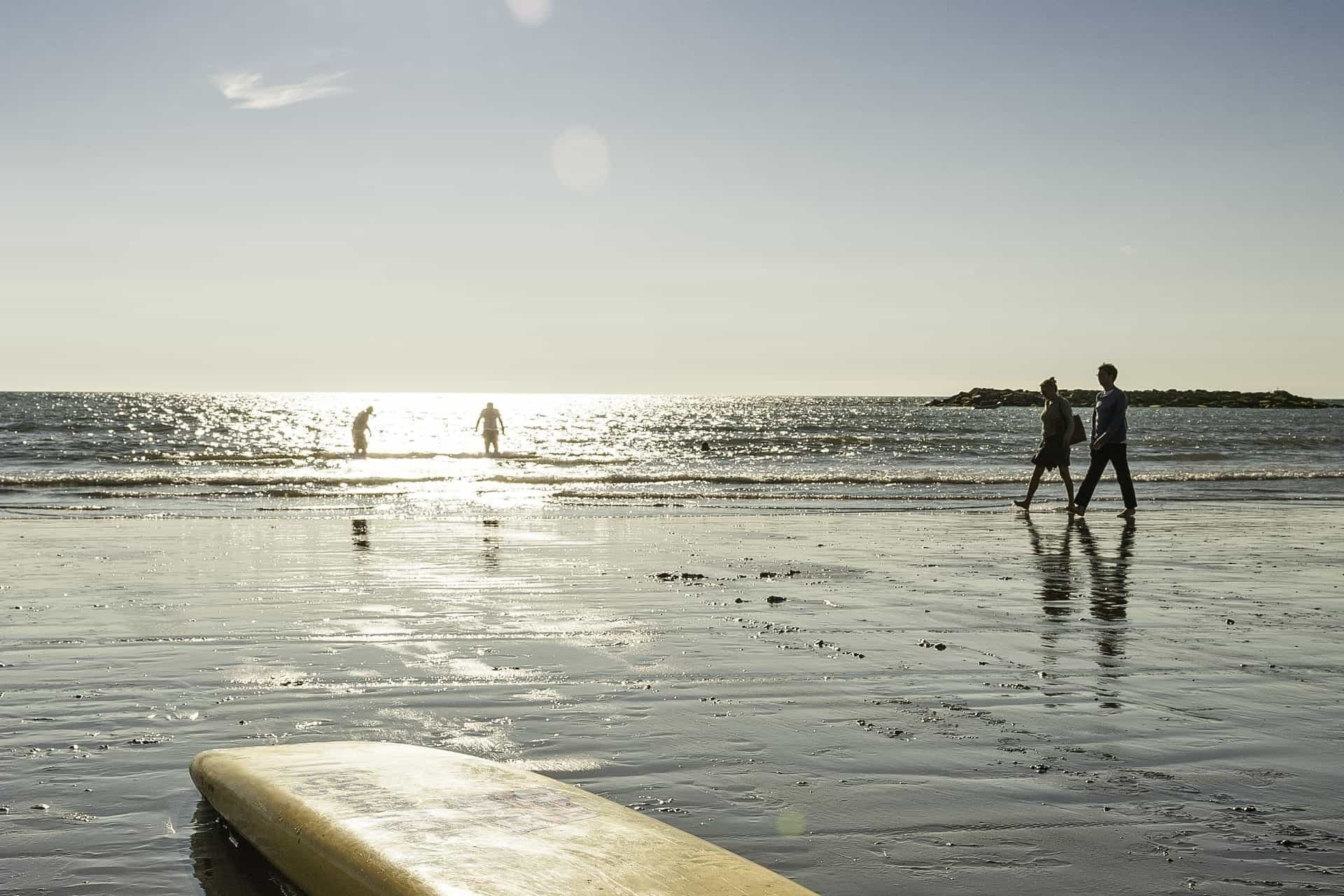 couple walking a beach in Wales near a Coastal Campsite