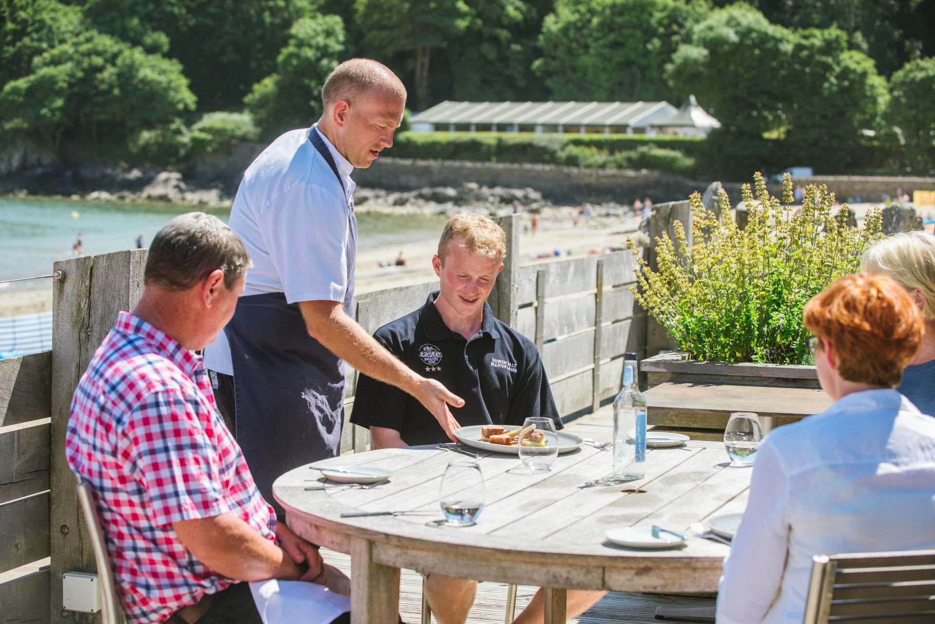 A stunning coastal restaurant view over the sands and water of Oxwich Bay on the Gower Peninsula.