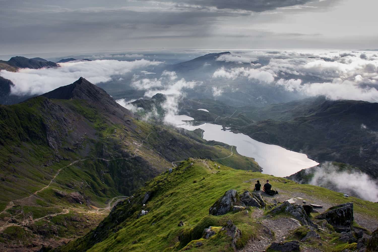 Walkers sitting down in Eryri (Snowdonia) National Park
