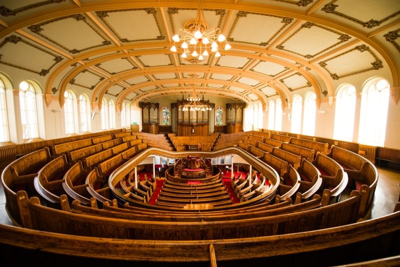 The Tabernacle Theatre in Swansea showing the wooden pews and small stage - one of the best looking theatres in Wales