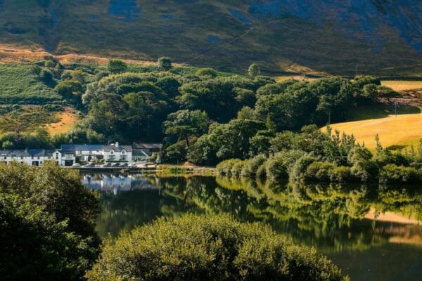 Tyn y Cornel Hotel in the distance with the river and fields in the foreground