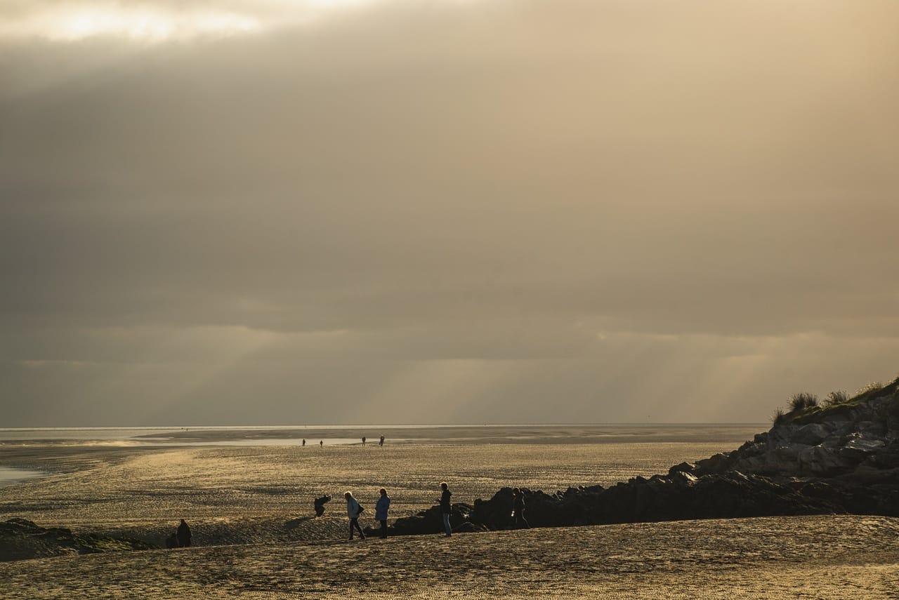 Sunsetting behind the clouds on a beach near Porthmadog