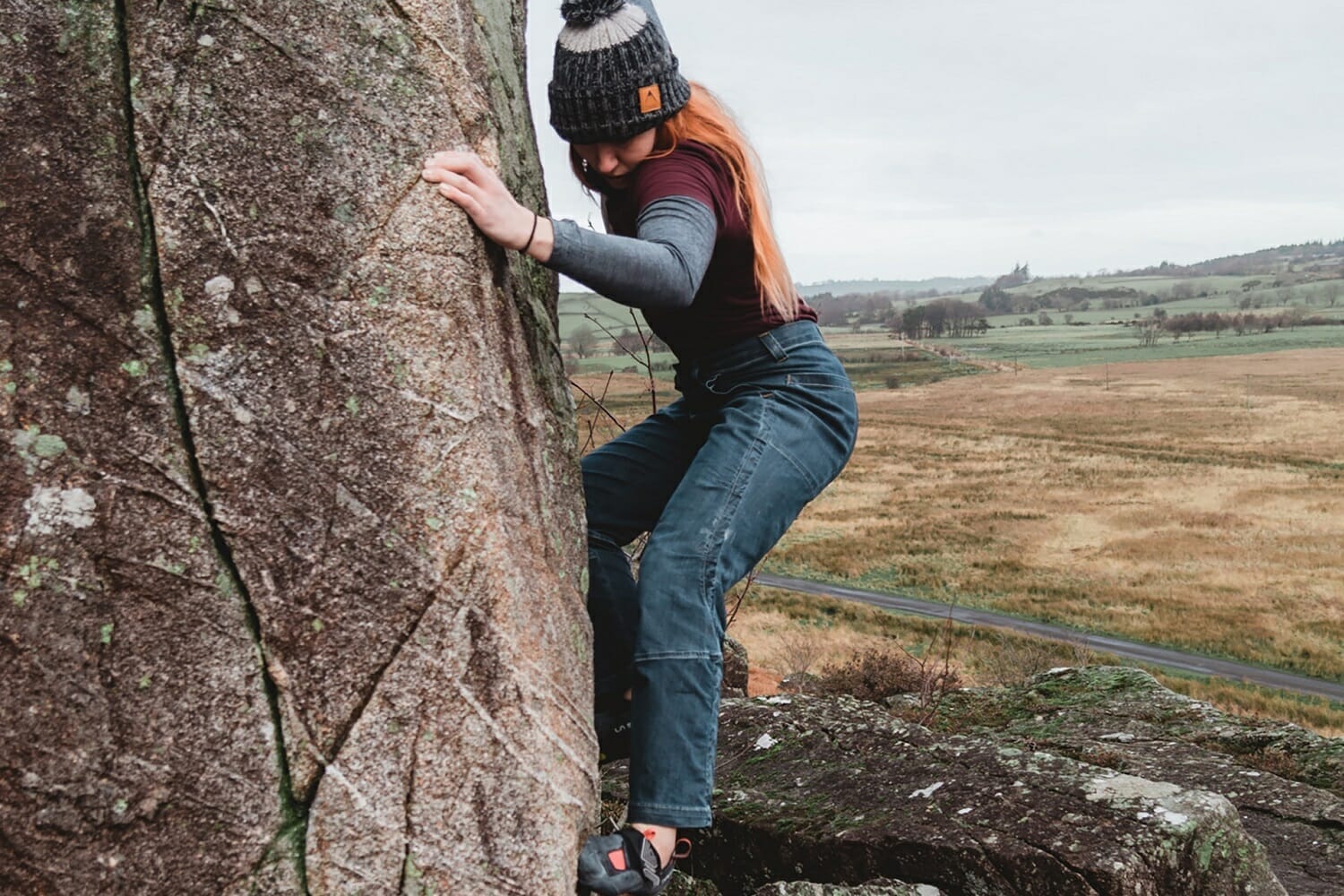 Woman bouldering in Wales