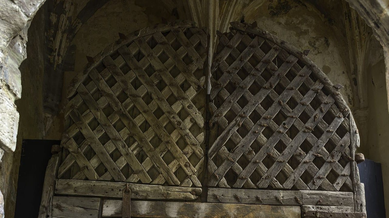 The iron-plated original wooden doors of Chepstow Castle's Great Gatehouse, dated to the 1190s and displayed inside the castle as the oldest surviving castle doors in Europe.