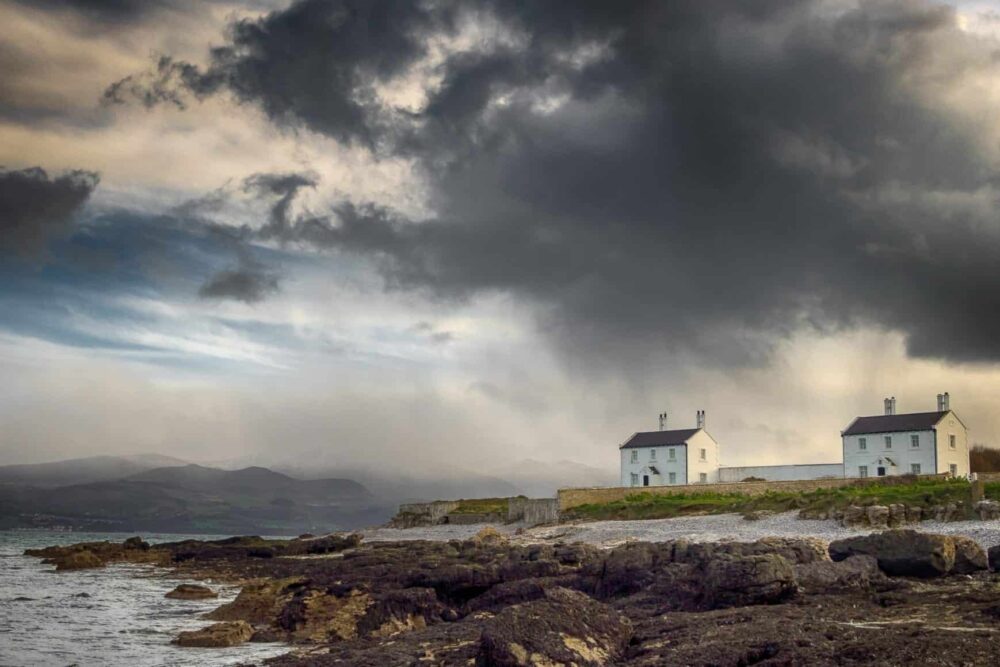 Stormy Sky with a cottage in the background at Penmon Point, Anglesey.