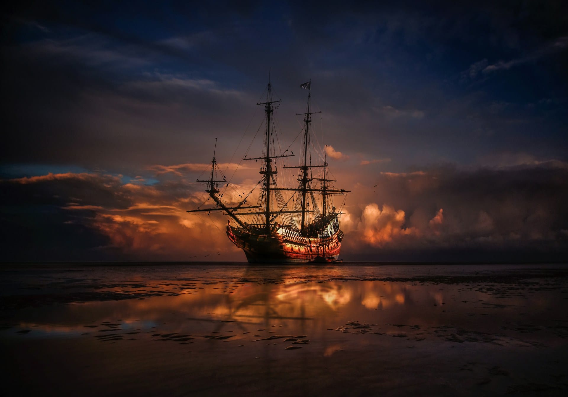 A traditional medieval wooden sailing ship with tall masts anchored in calm shallow waters at sunset, with dramatic golden light breaking through dark clouds and reflecting onto the water.