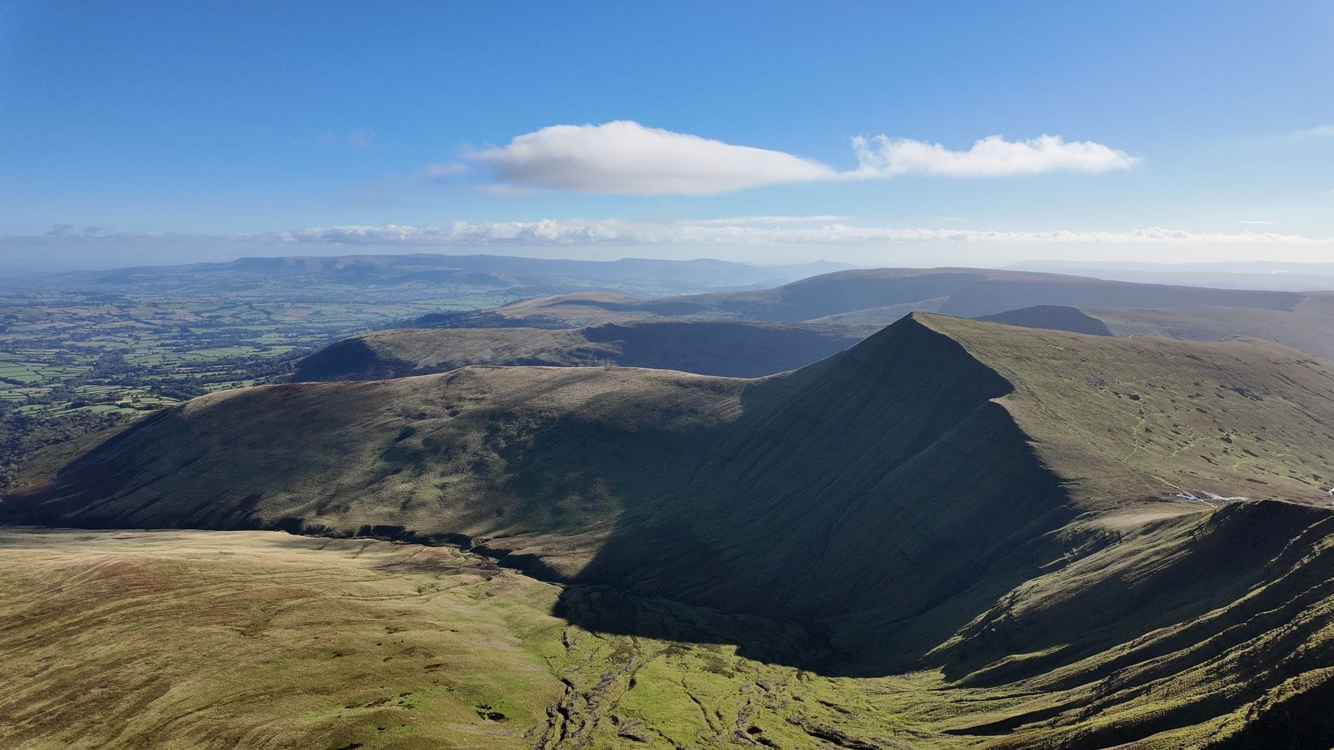 Panoramic winter view of the snow-covered peaks of Pen y Fan and Corn Du in the Brecon Beacons National Park.
