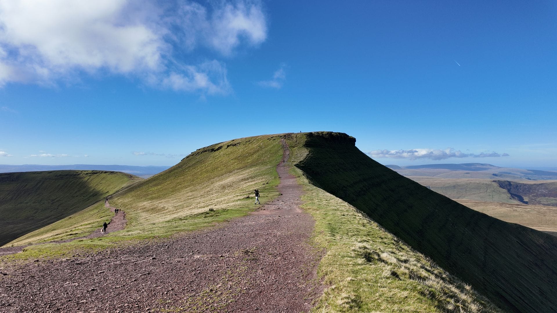 Stunning view of the steep horseshoe ridge leading towards the Pen y Fan summit bathed in afternoon sunlight.
