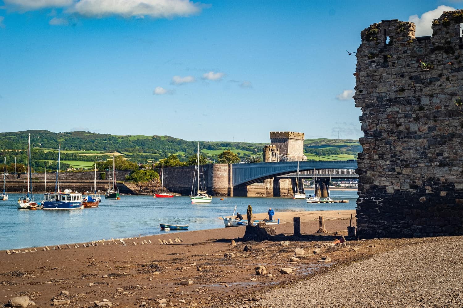 Conwy castle by the river with a bridge in the background