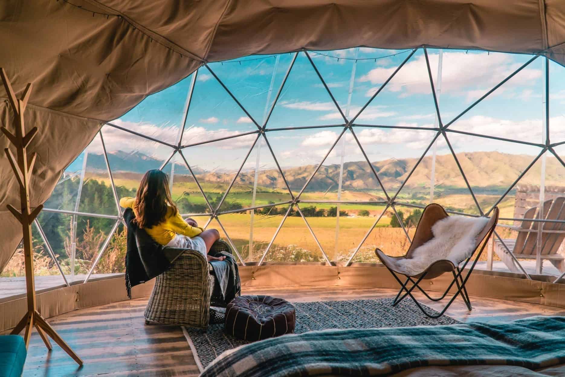 Woman Looking Out at Nature From Geo Dome Tent
