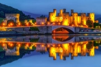 Conwy Castle lit up with lights at night