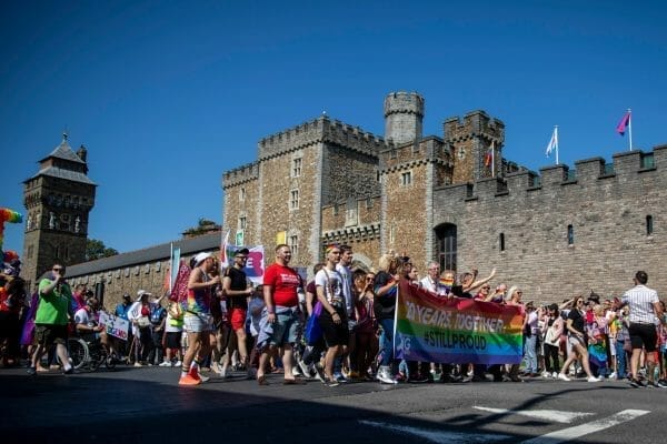 People marching pasting Cardiff Castle during Gay Pride