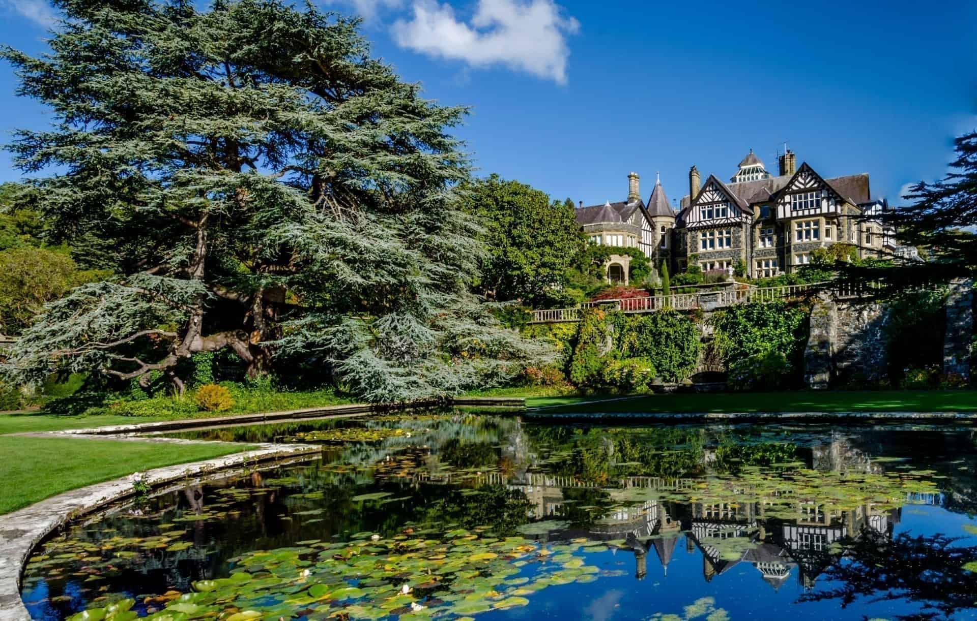 Garden pond in the foreground with the the estate house in the background, South Wales