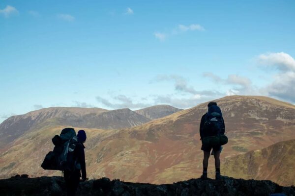 Two hikers in the Cambrian Mountains on bright sunny day