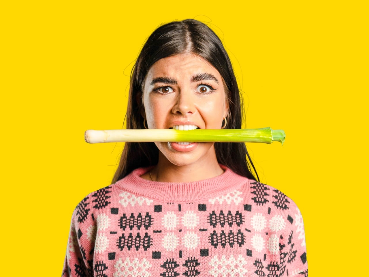Woman with a leek in her mouth - Fun Facts about Wales - The leek is the National Emblem of Wales